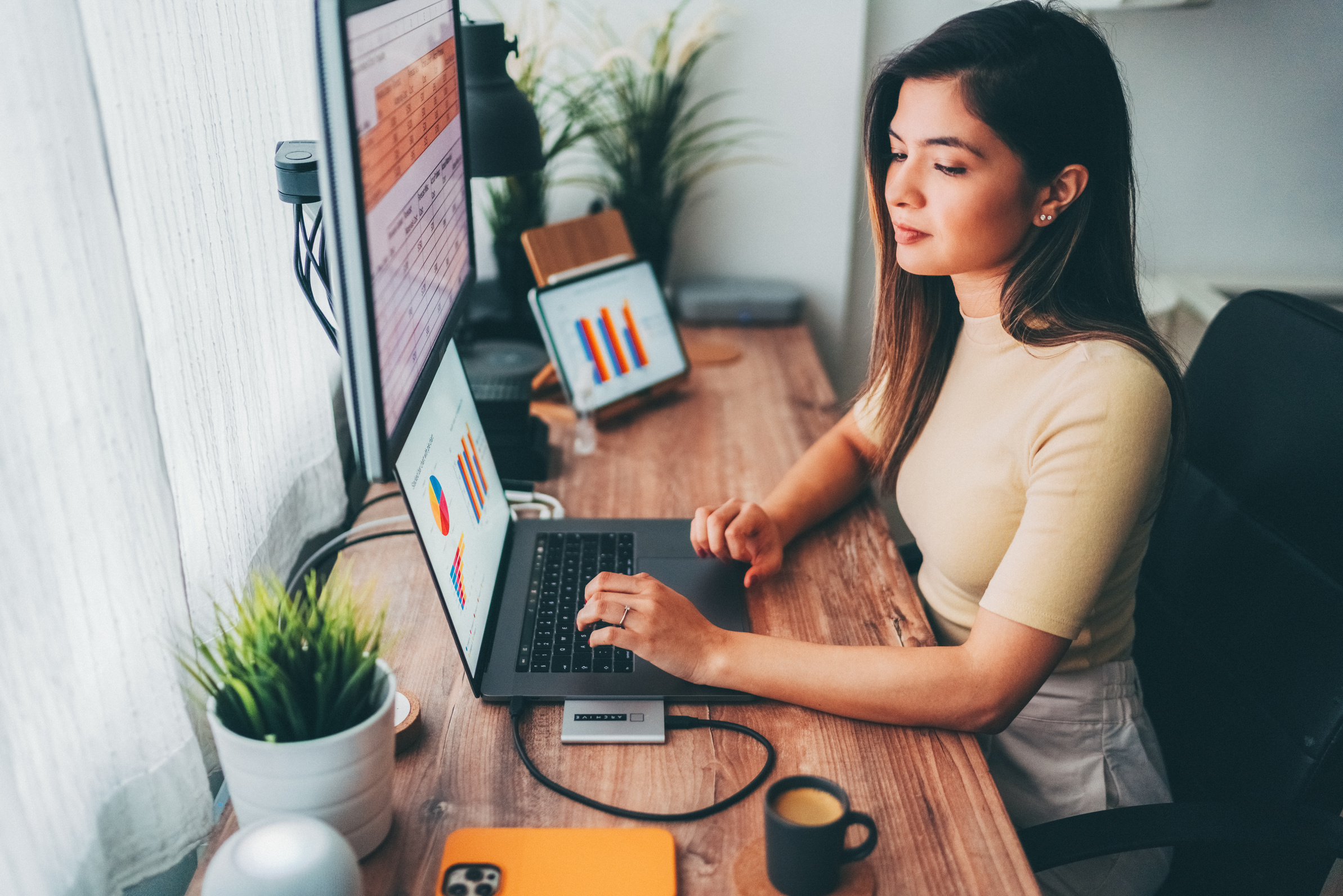 Woman working at home talks to virtual assistant